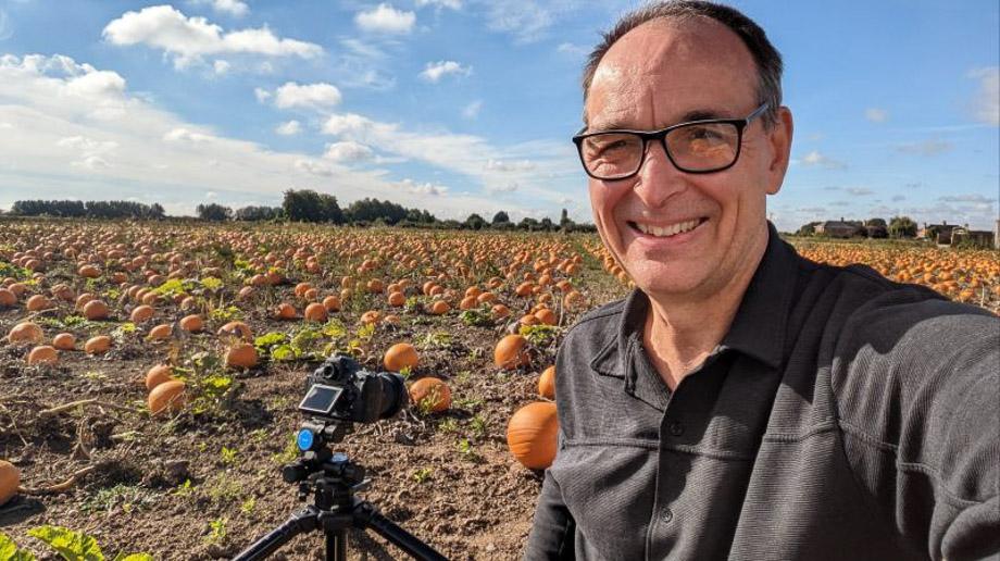 Photographer working in a pumpkin field
