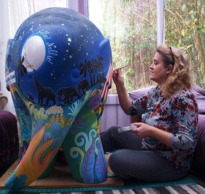 Emma Graham painting an elephant from the 2019 art trail, Elmer’s Big Parade Credit Lizzy Graham