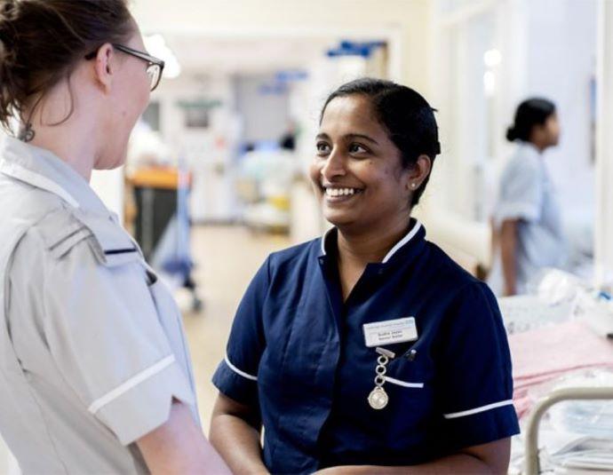 2 female NHS staff talking 