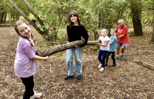Children holding a log