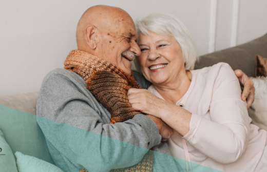 A mature couple cuddling on the sofa