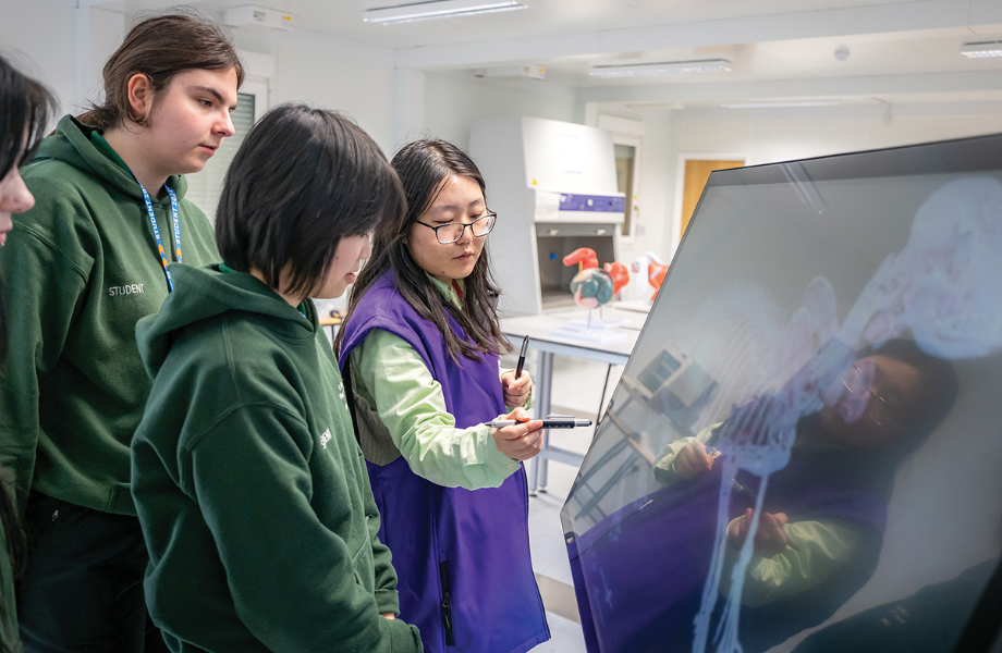 Group of students looking at a screen 