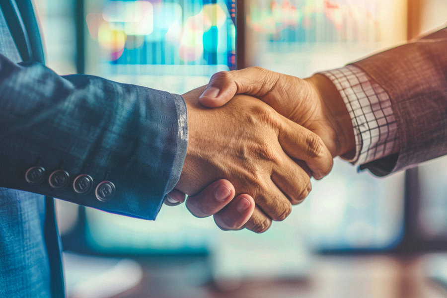 Two people shaking hands with each other.
