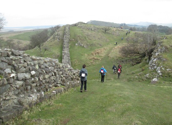 Walkers traversing the striking scenery of the Northumberland National Park along the Hadrian’s Wall Path in 2019 for Arthur Rank Hospice Charity 