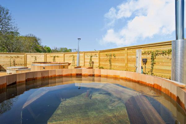 A photo of the spa area with the sky reflecting in the hot tubs