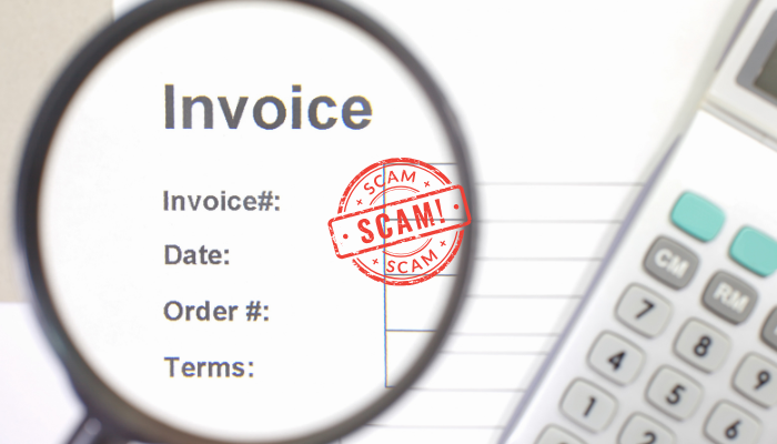 A picture of an accounting invoice, with a magnifying glass focussing in to scrutinise it and a calculator by its side. The invoice has been stamped with the word scam. 