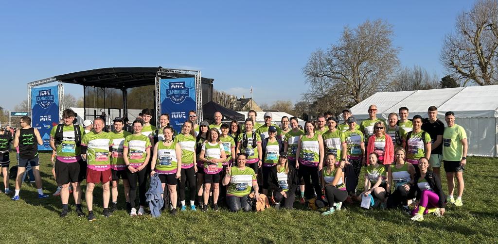 95 supporters in green running tops pose for group photo