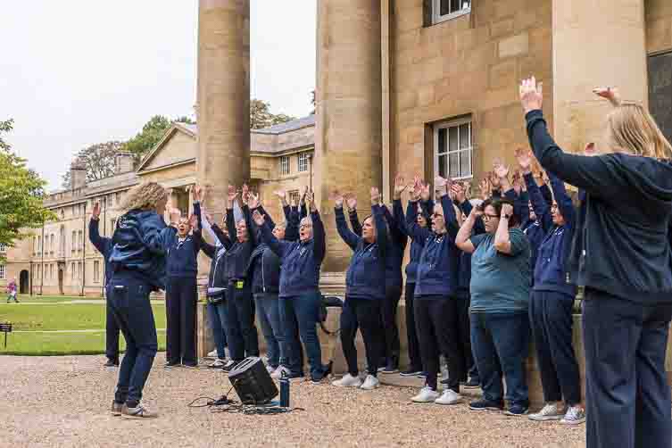 Males and females singing outside 