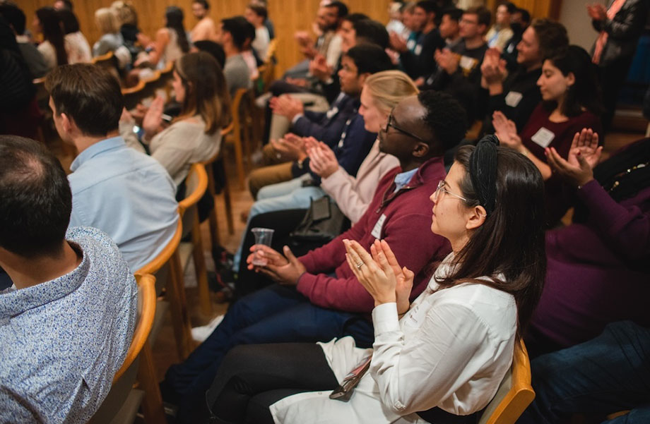 An audience applauding a speaker at an event