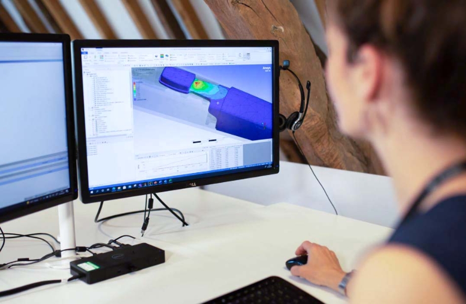 Image of a woman with an engineering model on a computer