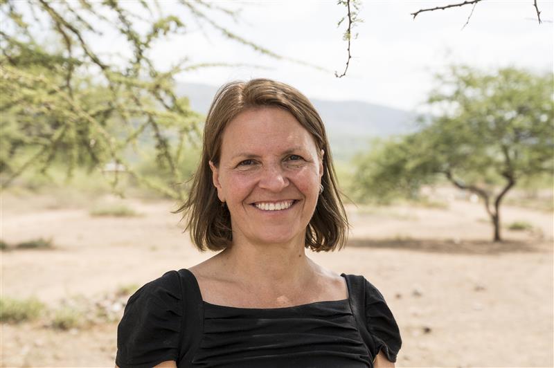Kirsty Smith, CEO, in Kenya. She is wearing a black top and is smiling.