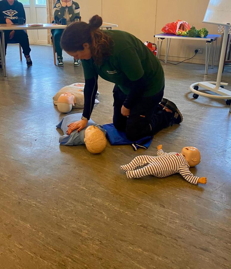 Administering first aid to a doll