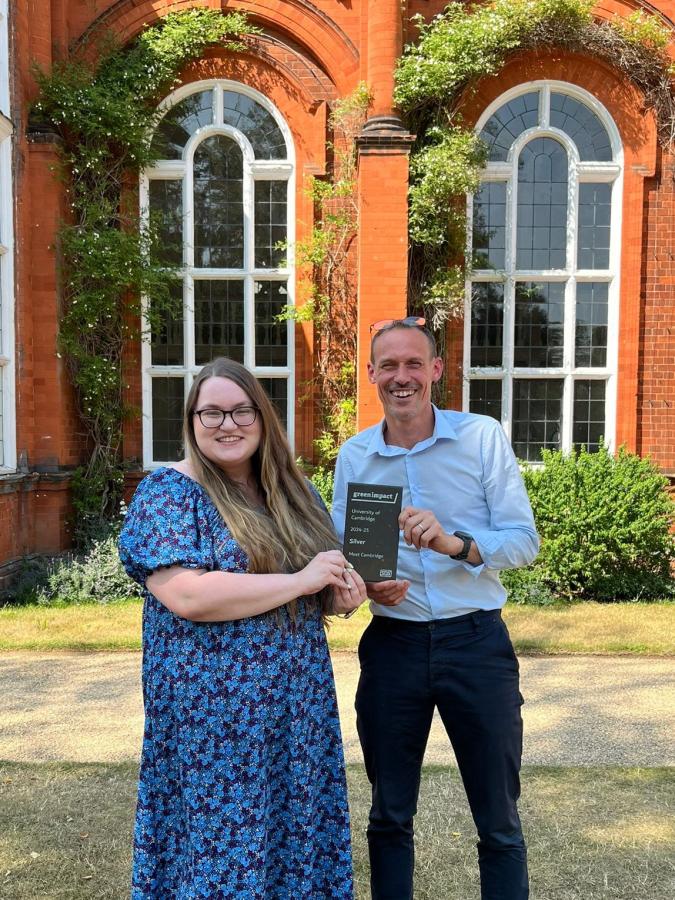 Meet Cambridge's Sarah Maycock and Andrew Bell with the Green Impact Silver award stading outside Newnham College, Cambridge