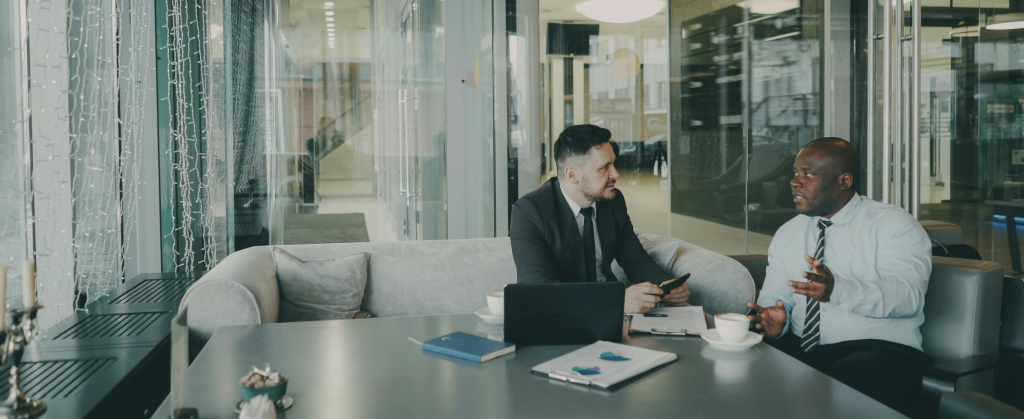 two men sitting down having a relaxed meeting