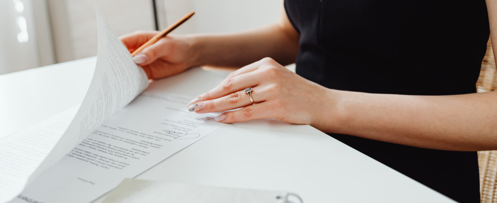 A woman signing some documents