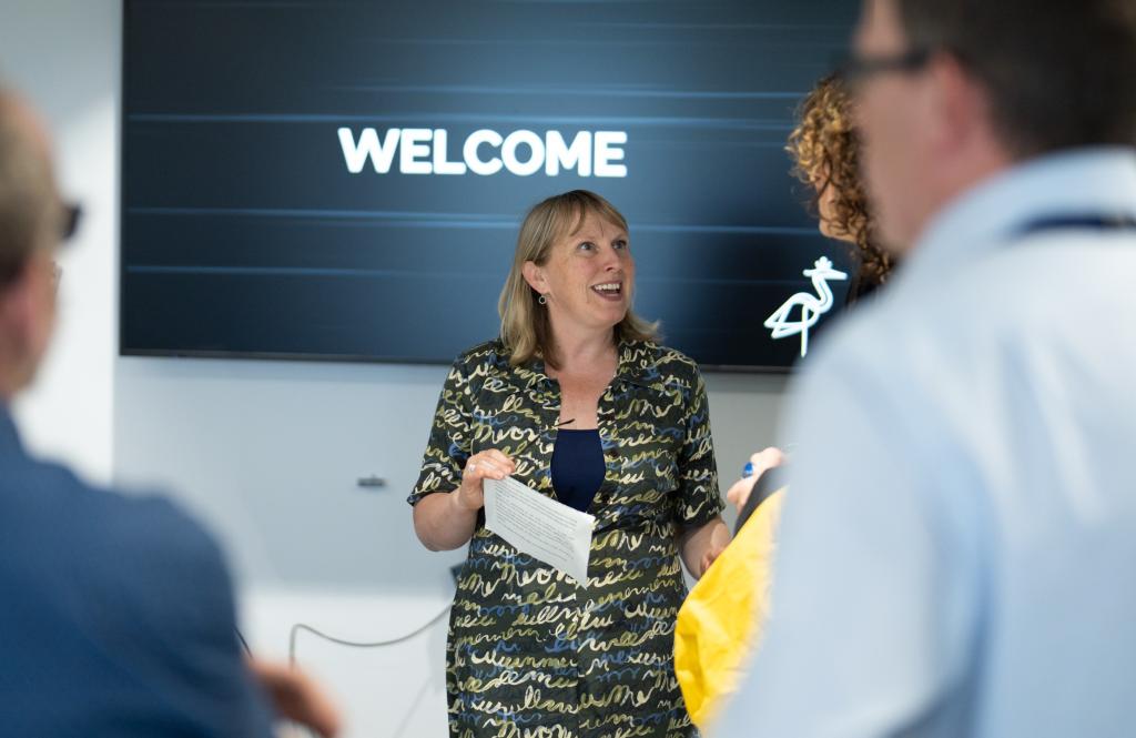 A female talking to a group of people