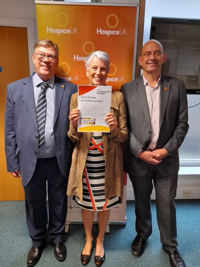 2 males and a female holding a certificate 