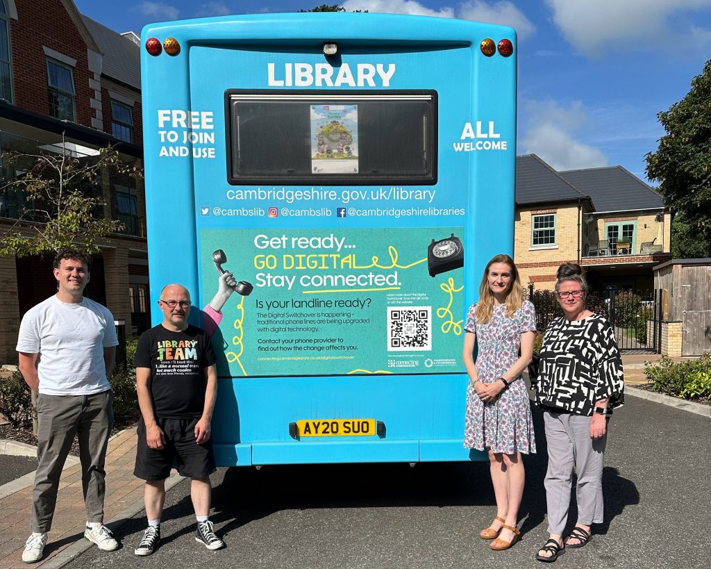 From left to right: Will Plant, Digital Inclusion Lead at Connecting Cambridgeshire; Darren Harte, Mobile Library Driver; Katherine Hesketh, Head of Communications at Keystone; and Chantal Palmer, Head of Creative at Keystone stand alongside one of the mobile library vehicles displaying the campaign graphics