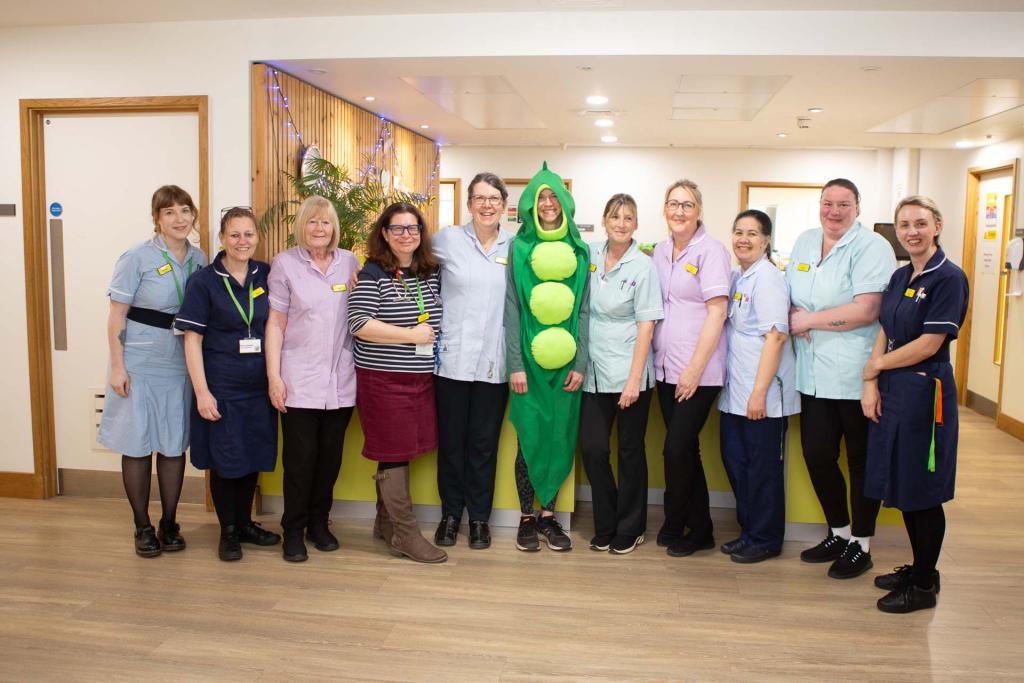 Person dressed in green with nurses