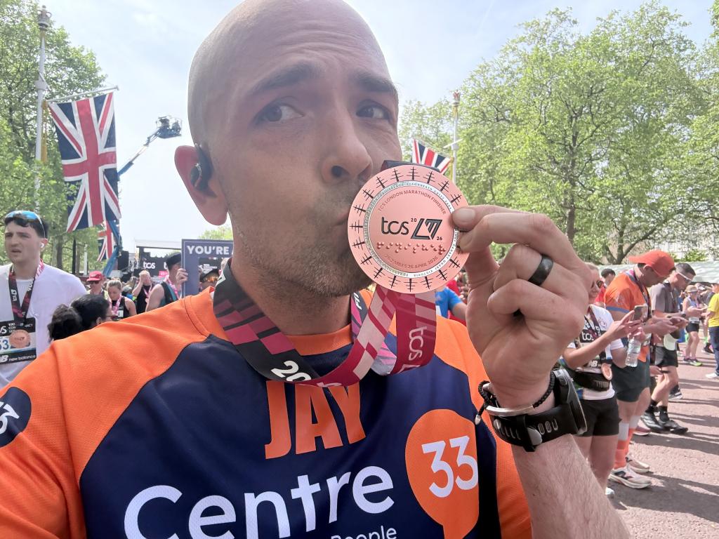 A Centre 33 runner, kissing his medal after completing the 2026 TCS London Marathon 