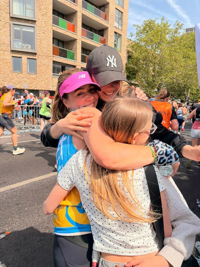 Lizzie hugging family after running London Marathon for Addenbrooke's Charitable Trust