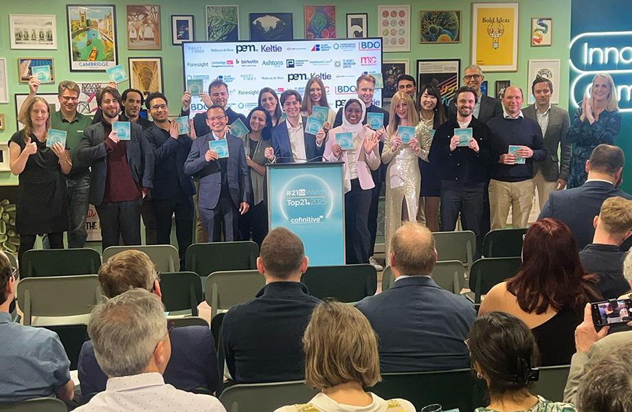 A group of people gathered around a podium holding award certificates