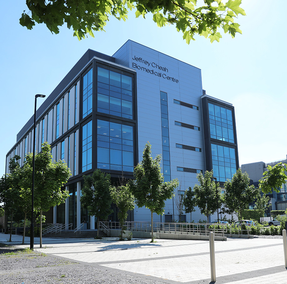 A glass and concrete building viewed from a distance in daylight