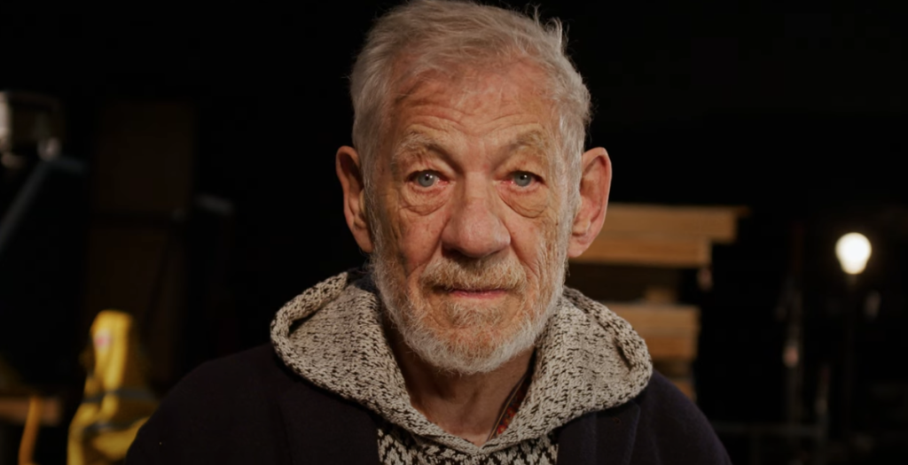 Sir Ian McKellen standing on the stage of Cambridge Arts Theatre