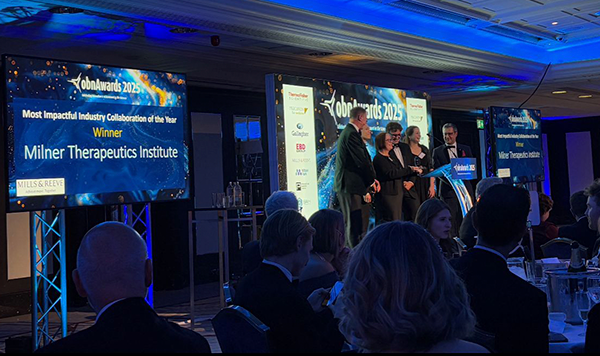 A stage, showing several team members accepting an award