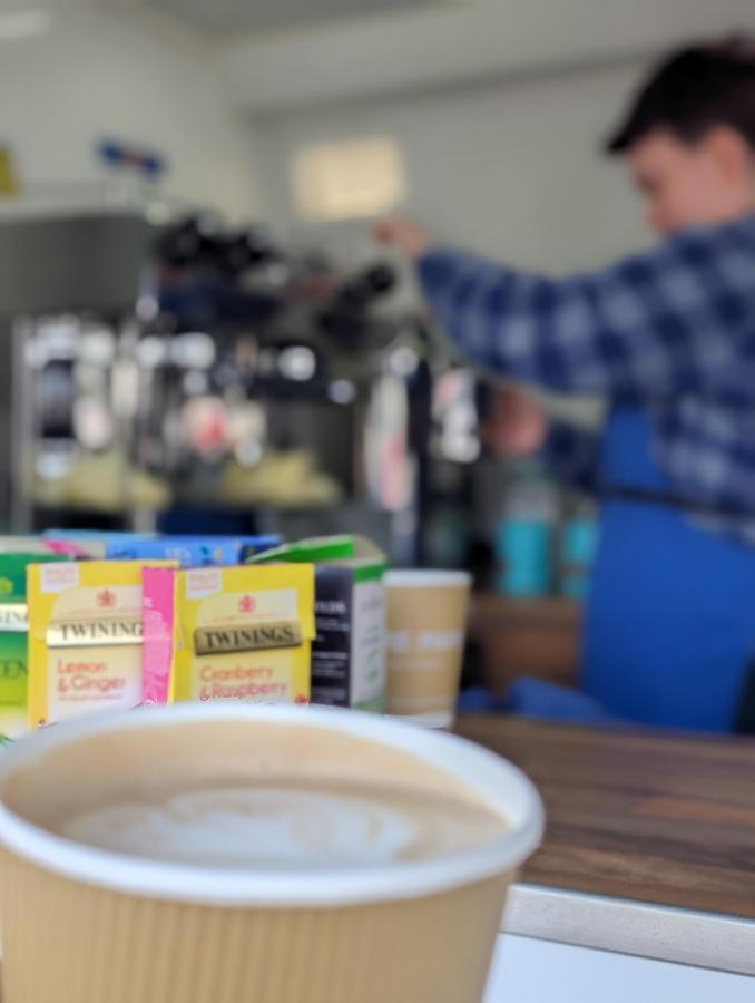 Young person using a coffee machine to make coffee