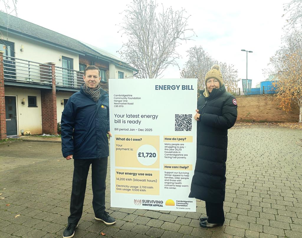 Cambridgeshire Community Foundation’s CEO, Michael O’Toole, and President, Julie Spence OBE QPM CStJ, holding an oversized energy bill.  