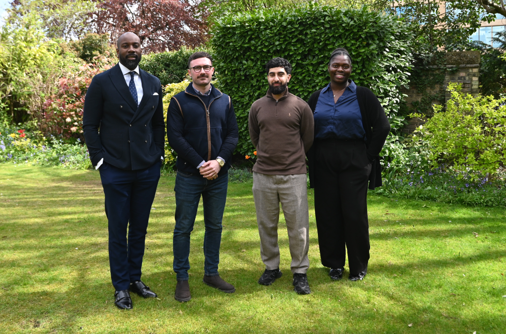 Three men and one woman in a garden