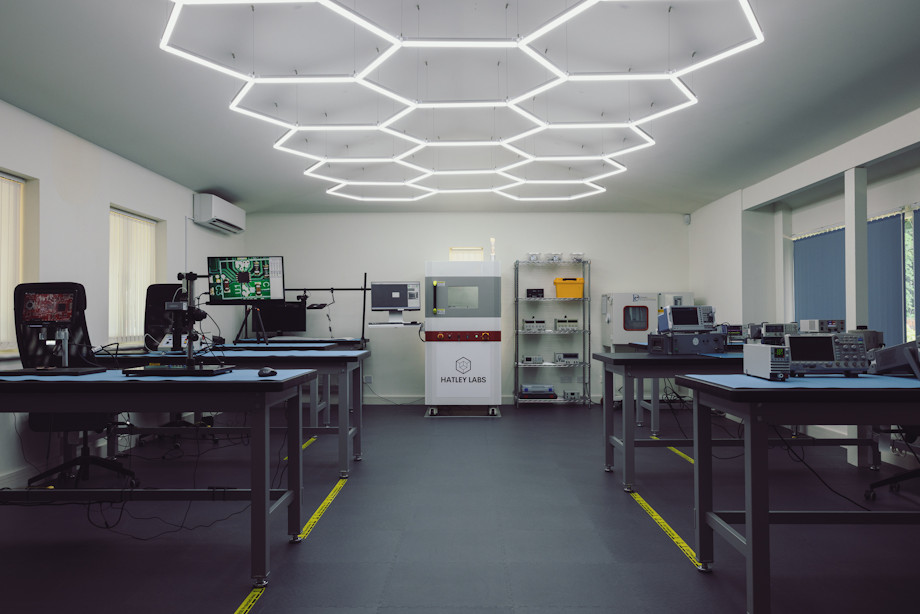product testing lab with equipment on work benches and an x-ray machine in the distance
