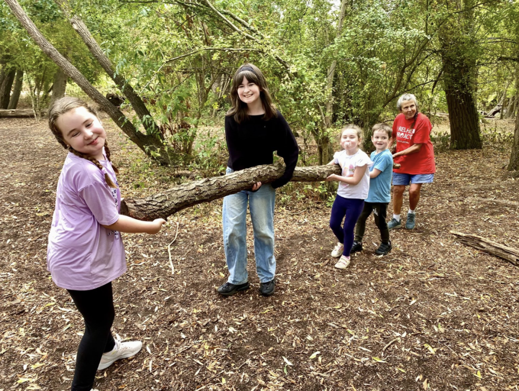 Children holding a log