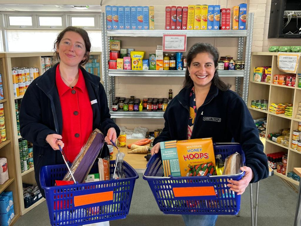 Rachel Karniely and Nicky Shepard holding baskets of food at Abbey Food Hub