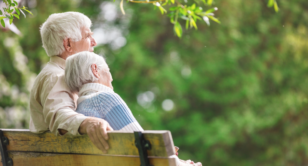 A mature couple sitting on a bench