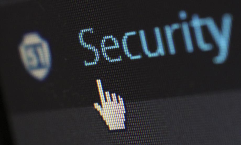 The word security typed on a screen on a black background with the hand shaped cursor hovering nearby
