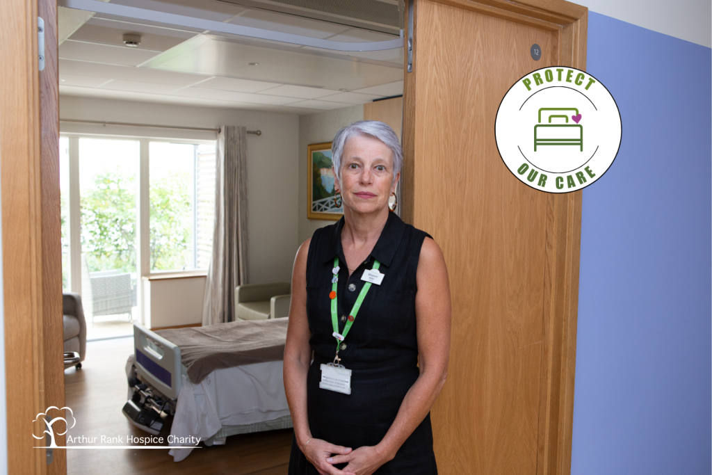 Female standing near a Hospice Bed 