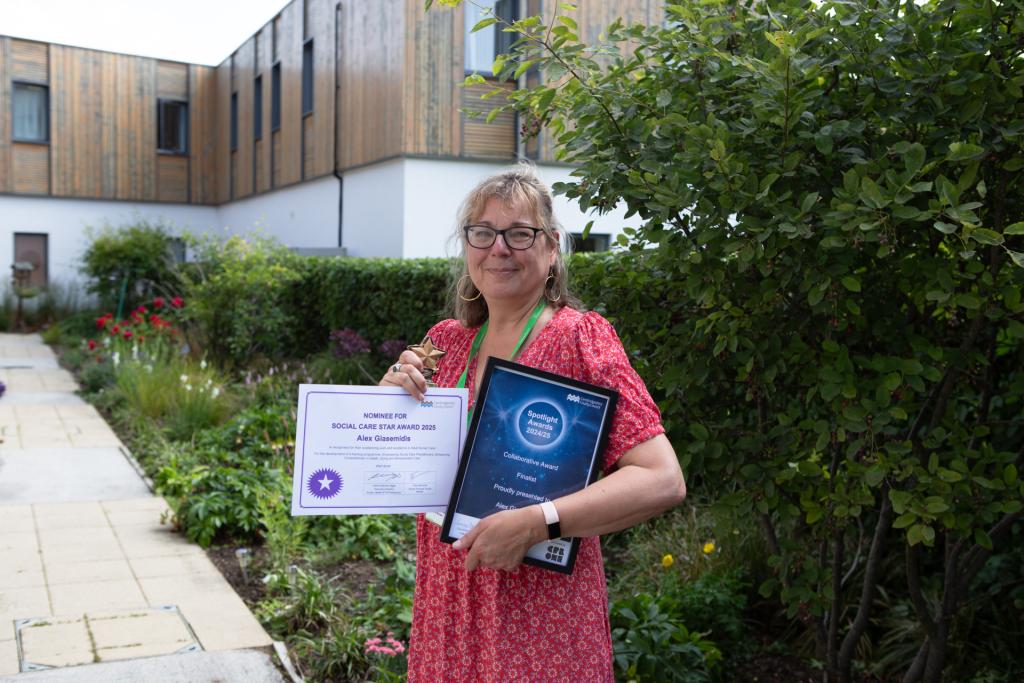Female outside holding certificates