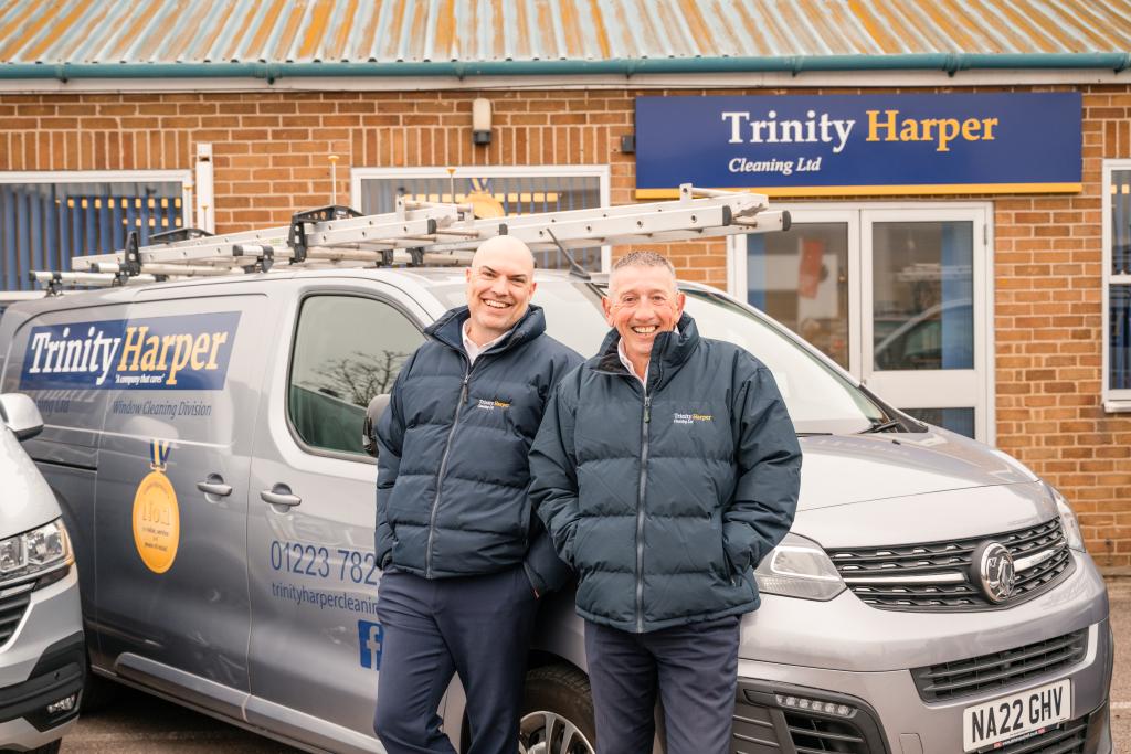 Paul and Barry from Trinity Harper cleaning smiling next to their vans