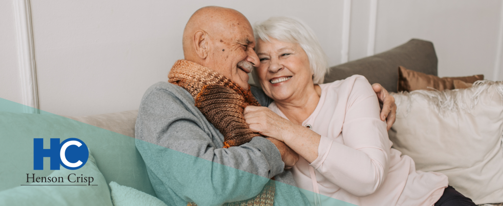 A mature couple cuddling on the sofa