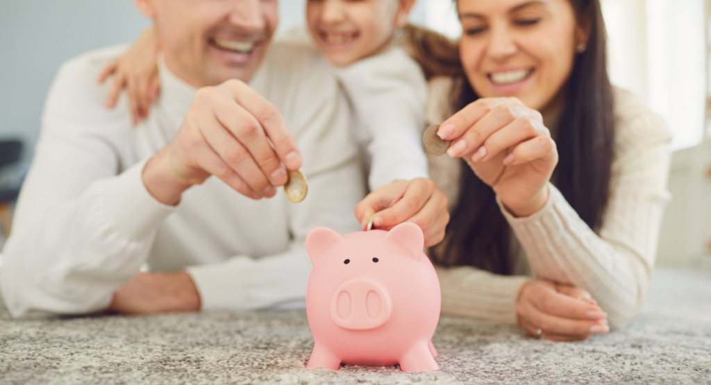 A family putting coins in a piggy bank