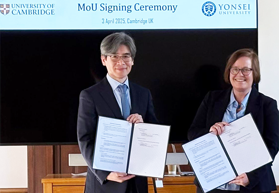 Representatives of Yonsei University and the Milner Institute holding signed copies of their new agreement