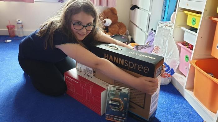 Delighted girl receives a Raspberry Pi computer