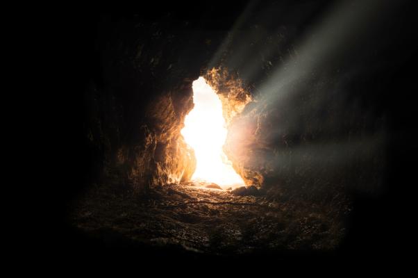 a cave with the light shining through