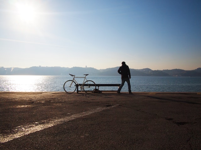 Person on a beach with bicycle