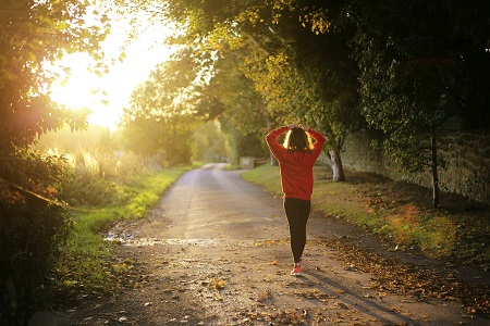 Runner in sunlight on a country path