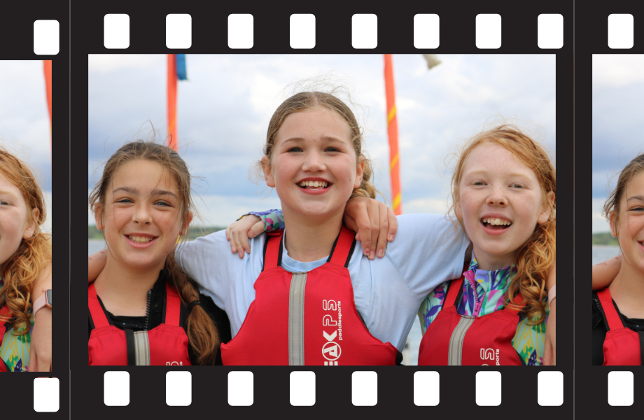Image of film strip showing three smiling girls wearing lifejackets