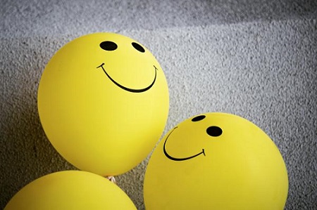 balloons with happy face emojis