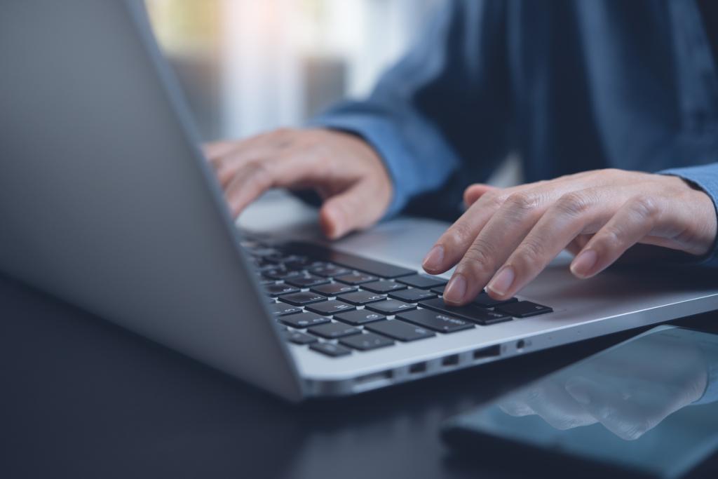 man typing on laptop 